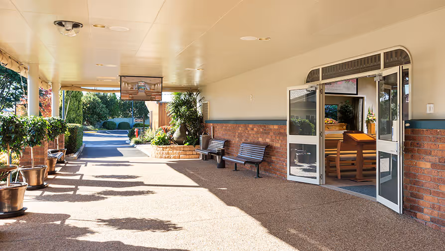 Covered walkway with seating at a funeral home.