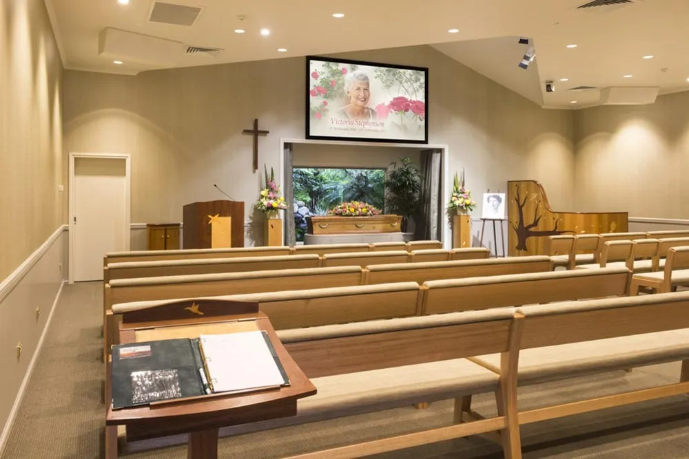 Chapel interior with pews, screen, and podium.