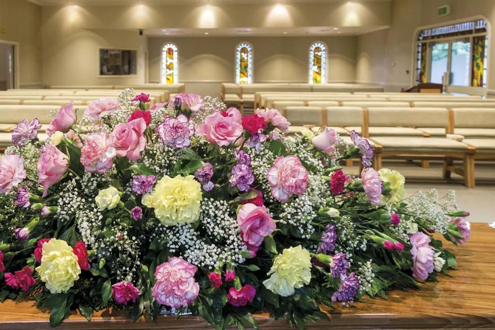 Large floral arrangement with pink, yellow, and white flowers.