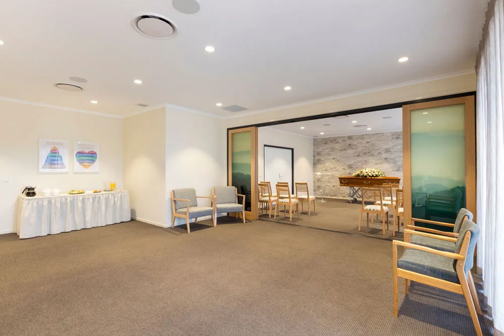 Spacious room with large windows and natural light.