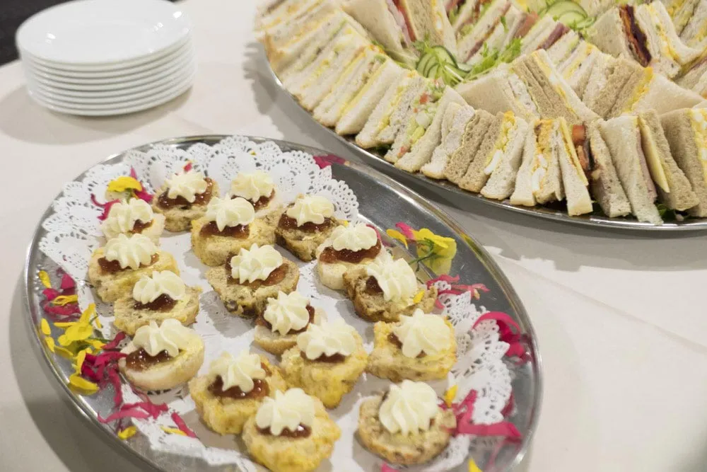 Plates of savory snacks and appetizers on a buffet.
