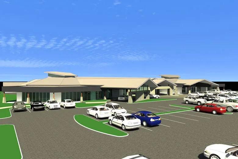 Parking lot with various cars, modern complex.