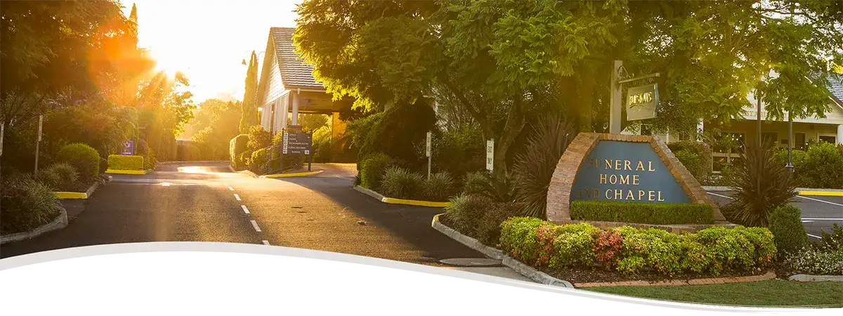 The tree-lined entrance to the TS Burstow Funeral Home and Chapel at sunrise